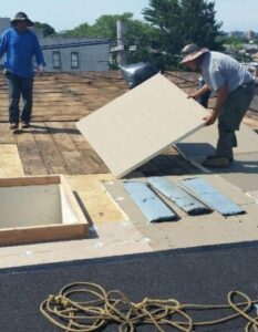 Goldenberg-Roofing-NYC-flat-roofing-repairing-material-worker-doing repair